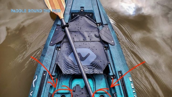 View from above of a blue kayak on water, showing kayak scupper plugs